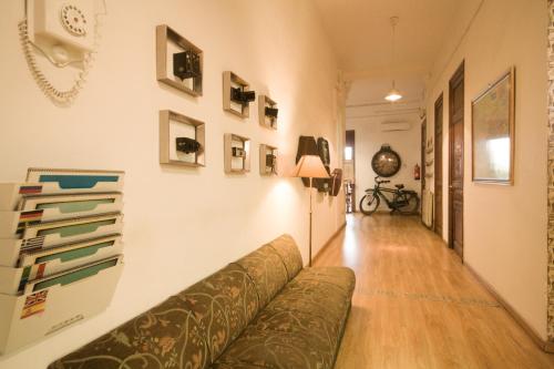 a living room filled with furniture and a wall at The Hipstel Paseo De Gracia in Barcelona