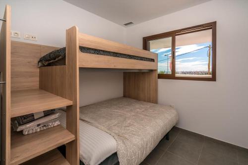 a bedroom with two bunk beds and a window at Maestro in San Juan de los Terreros