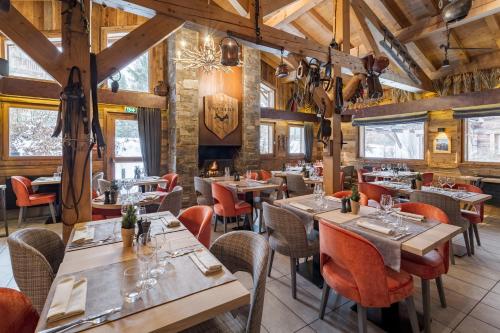 a large dining room with tables and chairs at Les Loges Blanches in Megève