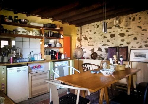 a kitchen with a wooden table and chairs in it at Vitsi Lodge in Sidhirokhórion