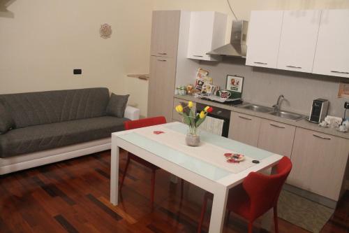 a kitchen and living room with a table and a couch at Dimora di Mara in Santeramo in Colle