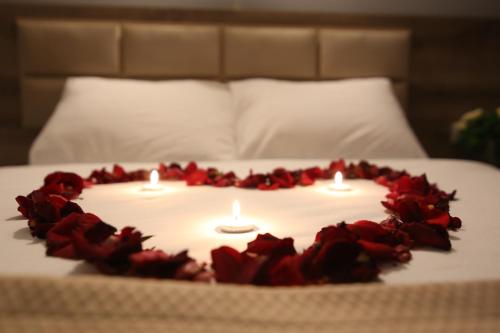 a cake with candles and roses on a bed at kocatepe hotel in Ankara