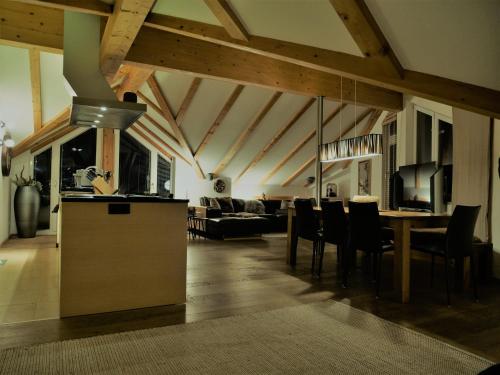 a kitchen and living room with a table and chairs at Dorfplatzl in Ischgl