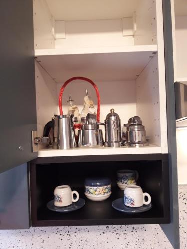 a cupboard filled with pots and pans at b&b Tosches in Barletta