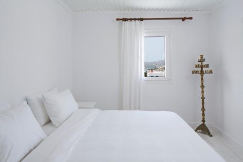 Ένα ή περισσότερα κρεβάτια σε δωμάτιο στο Aether Boutique Stay