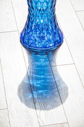 a blue glass vase sitting on a tile floor at Aether Boutique Stay in Glastros