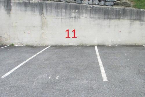 a parking lot with the number on the wall at Studio LE COL DU TOURMALET 2-4 pers linge parking wifi in Barèges