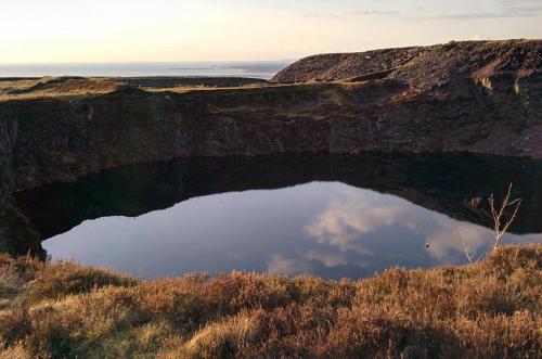 a reflection of the sky in a pool of water at Canolfan Y Fron in Caernarfon