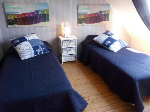 una camera con due letti e un comodino di La baie a Saint-Jean-du-Doigt