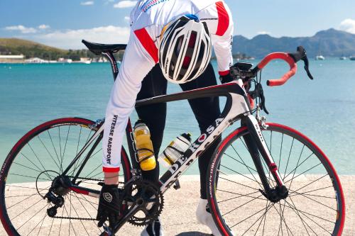 a man is riding a bike on the beach at Alcudia Garden Aparthotel in Port d'Alcudia