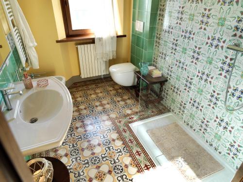 a bathroom with a sink and a toilet and a shower at Podere Terreno alla via della volpaia in Radda in Chianti