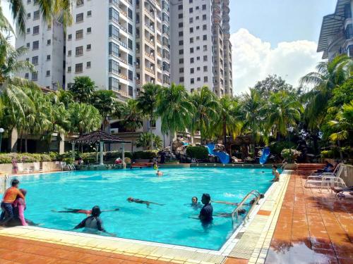 a group of people in a swimming pool in a city at Costa Mahkota (Family Homestay) @ Mahkota Melaka in Melaka