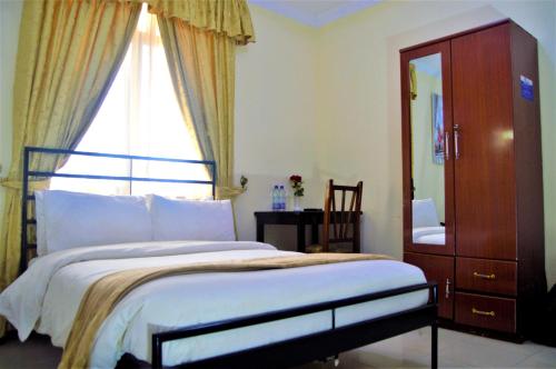 Postel nebo postele na pokoji v ubytování M Hotel