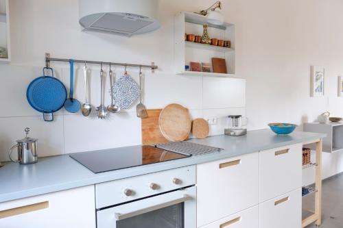 a kitchen with white cabinets and a blue counter top at Fewo-Mundi in Egestorf