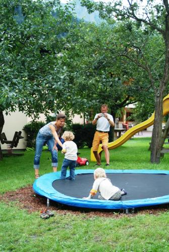 a group of people playing on a trampoline at Landhaus & Appartementhaus Haussteiner in Dorfgastein