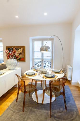 a dining room with a table and chairs at Tergesteo Palace Suite in Trieste