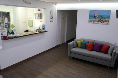 a living room with a couch and a coffee table at Color Suites Alicante in Alicante