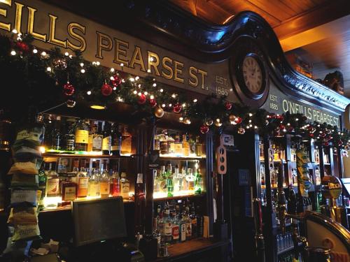 a bar with a lot of bottles of alcohol at O'Neills Victorian Pub & Townhouse in Dublin