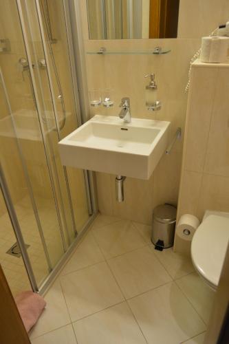 a bathroom with a sink and a shower at Frühstückspension Christina in Tux