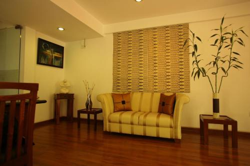 a living room with a couch and two tables at juSTa Off MG Road in Bengaluru