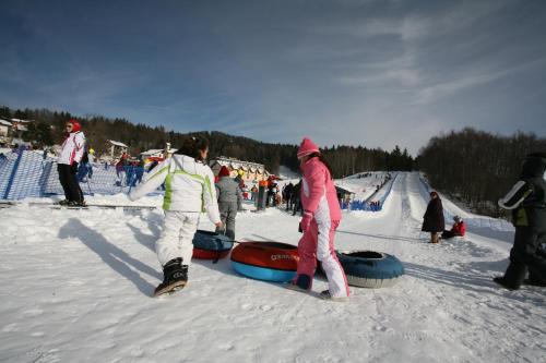 a group of people standing around in the snow at Chalet Laila in Folgaria
