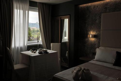 a hotel room with a bed and a window at La Vigna Hotel in Bonea