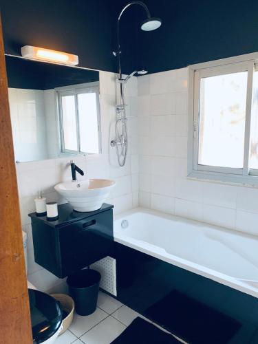 a bathroom with a sink and a bath tub and a sink at Nandy's home in Odza II