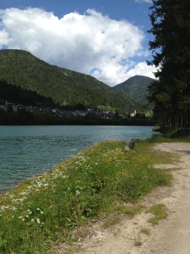 a dirt road next to a body of water at Hotel al Sole in Auronzo di Cadore