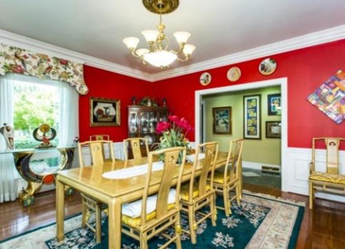 a dining room with red walls and a table and chairs at Matthews Manor Bed & Breakfast in Charlotte