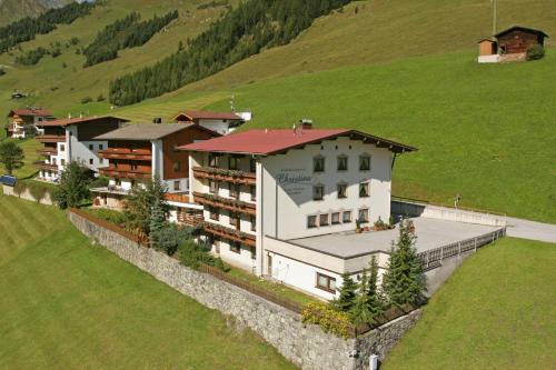 an aerial view of a building on a hill at Frühstückspension Christina in Tux