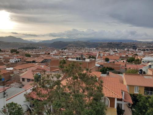 a view of a city with houses and mountains at El Jardin De Su Merced B&B in Sucre