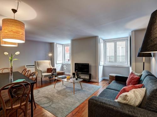 a living room with a couch and a table at Canaan Lifestyle Apartments Lisbon Combro 77 by Get Your Stay in Lisbon