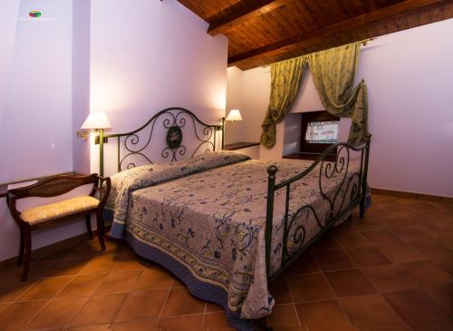 1 dormitorio con 1 cama y 1 silla en B&B Il Casone di Drusa, en San Marco dei Cavoti