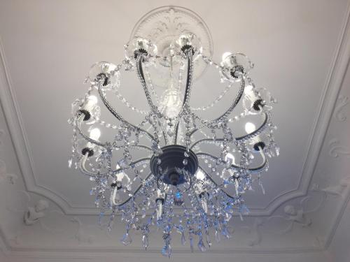 a chandelier is hanging from a ceiling at Les Suites du Cours & Spa in Aix-en-Provence
