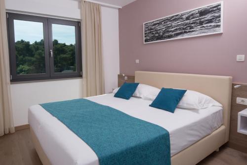 Katil atau katil-katil dalam bilik di Aparthotel Punta Blu - POOL & SPA