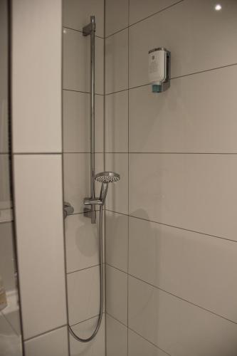 a shower with a shower head in a bathroom at Gasthof Zur Post in Schwabhausen bei Dachau