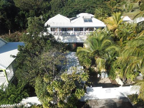 a house with a bridge over a river with trees at La plage de Petit-Havre in Le Gosier