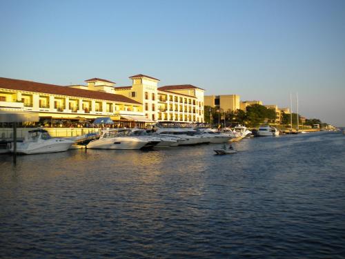 a group of boats docked in a river with buildings at Delamar Greenwich Harbor in Greenwich