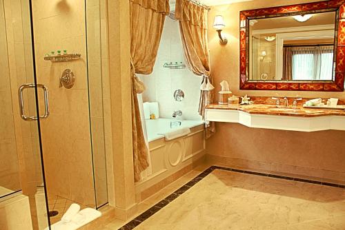 a bathroom with a shower, sink, and toilet at Delamar Greenwich Harbor in Greenwich