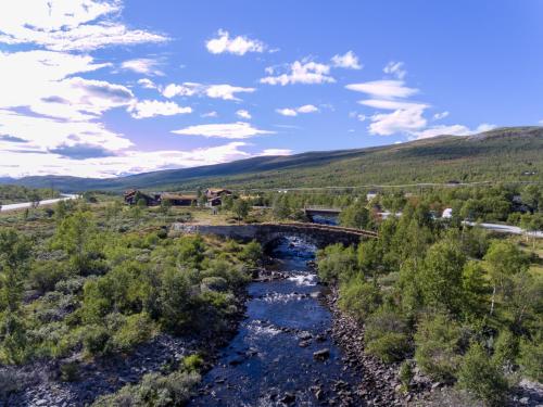 an aerial view of a bridge over a river at Dovregubbens Hall in Vålåsjø