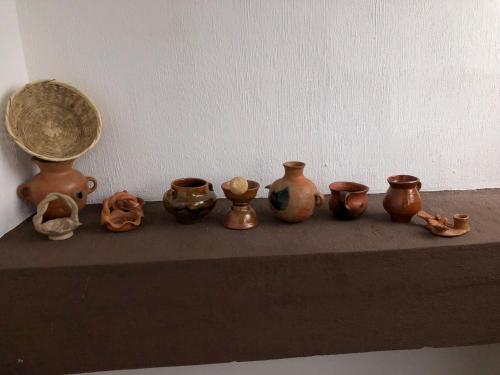 a group of copper vases sitting on a shelf at Casa Imelda, Atitlan in Sololá
