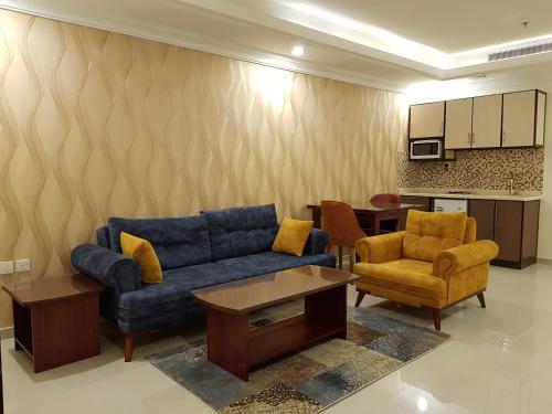 a living room with a blue couch and chairs at ضيافة بلس شقق مخدومة أقتصادية Dyafah plus 2 in Jeddah