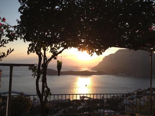 a man standing in front of the ocean at sunset at Elsa's house in Kalymnos