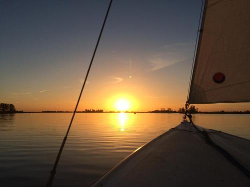 a view from the bow of a sail boat at sunset at Vakantie Studio Grou in Grou