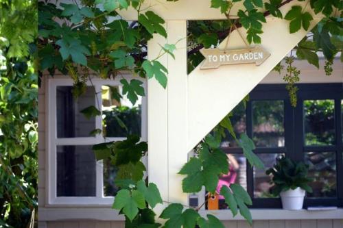 a sign on the side of a house with a window at COSY & NATURAL *FIREPLACE*GARDEN*2 BIKES in Heinenoord