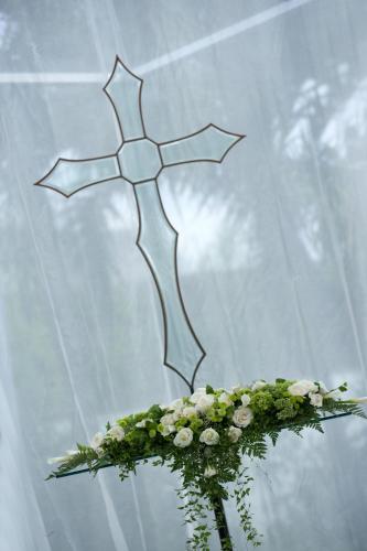 a cross on top of a vase with flowers at The Kunja Villa-Hotel in Seminyak