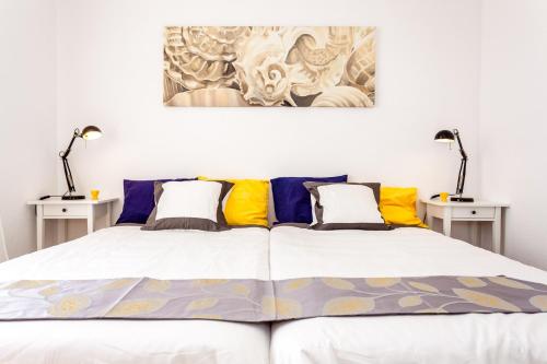 a bedroom with a large bed with two tables at Cielo Azul in La Tejita