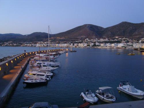 a group of boats are docked in a harbor at Aris Studios in Hersonissos