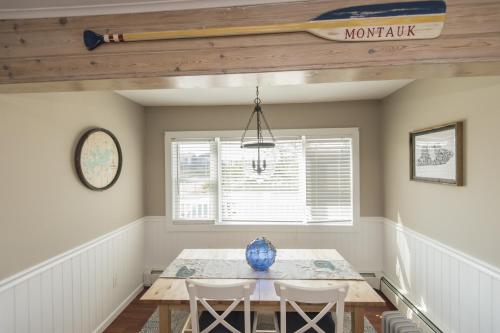 a dining room with a table and chairs at The Montauk Soundview in Montauk