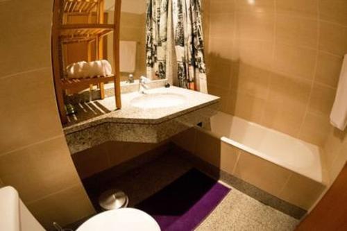 a bathroom with a sink and a toilet at PERFECT DUPLEX PISCINE Zone VIP Funchal in Funchal